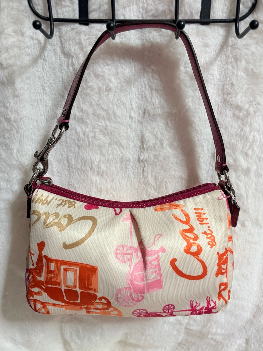 Coach mini shoulder bag features a vibrant multicolored horse and carriage print